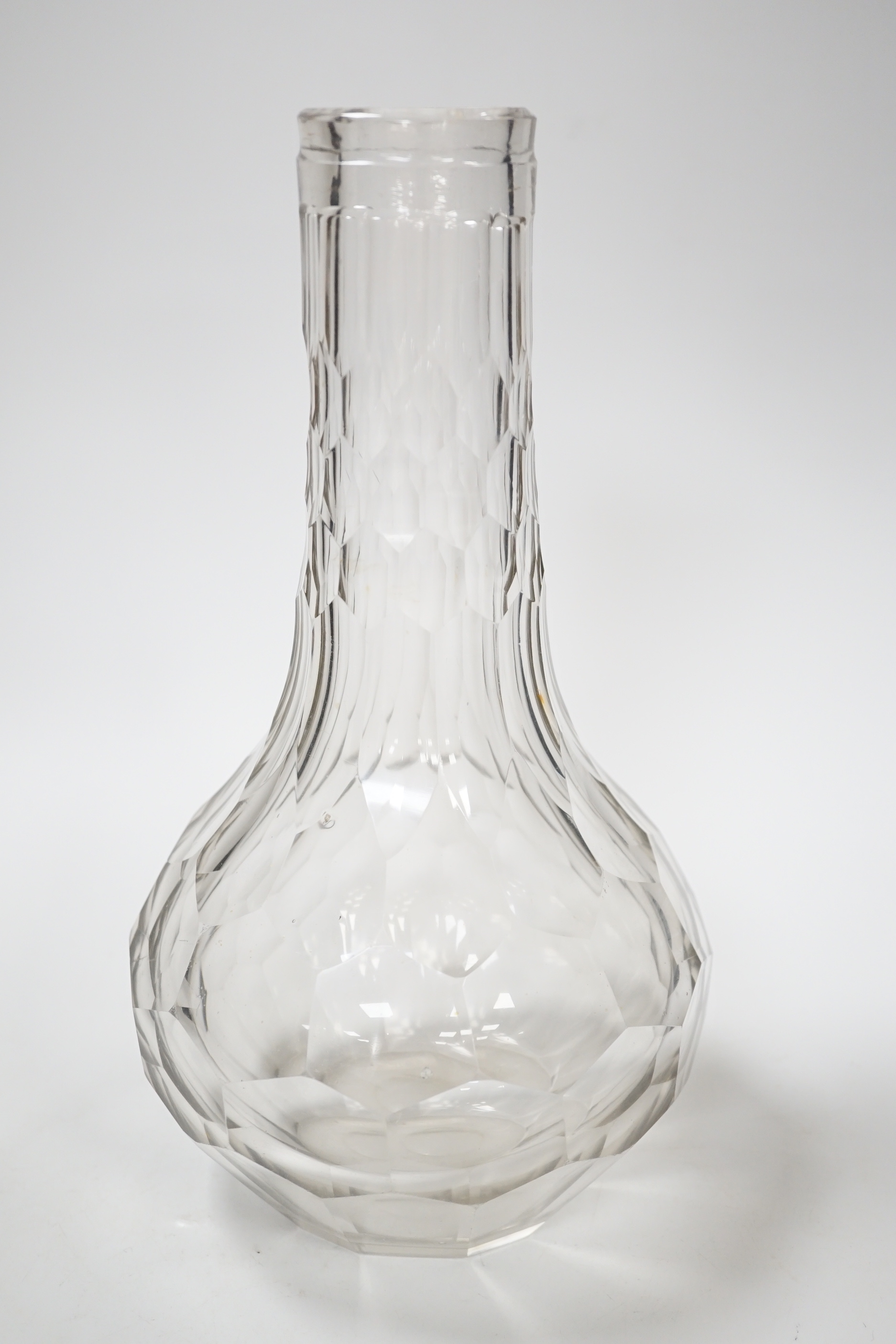 An English lead crystal facetted carafe, 18th century, the whole of the shaft and globe form is decorated with short and long hexagonal facets, the pontil is ground and polished, fine lilac tinge to metal, 28cm high